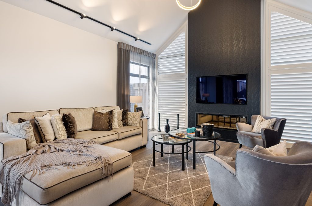 Oakbridge living room by Hallmark Homes Christchurch showcasing contemporary design and build with neutral furnishings, feature fireplace wall, and premium finishes