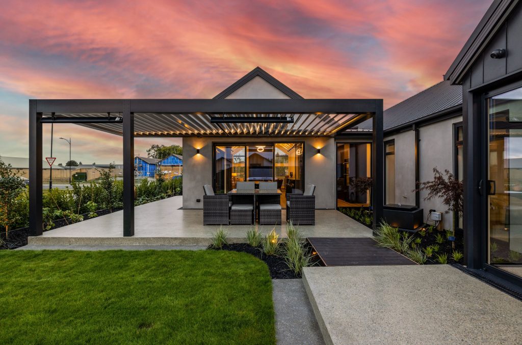 Hallmark Homes Oakbridge outdoor living area with pergola and alfresco dining at sunset - Christchurch custom home design and build