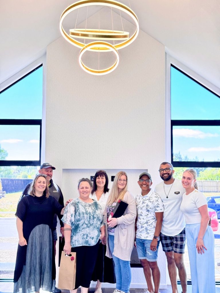 Hallmark Homes family and clients group photo in stunning living room - walk in as clients leave as family, Christchurch bespoke home builders Marshlands
